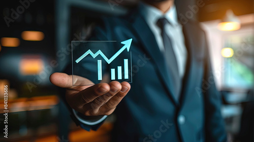 Business growth concept. Businessman hold up arrow icon and percentage with graph indicators for investment growth. Strategic business success. Business vision.