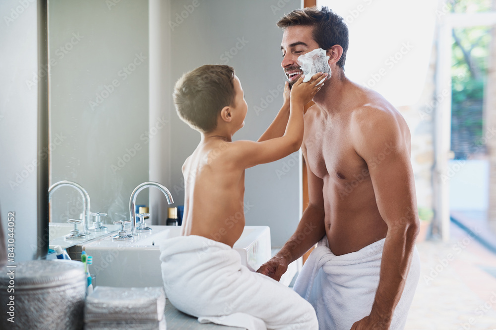 Shaving cream, helping and child with father in bathroom for hygiene, grooming and health routine. Bonding, hair removal and boy kid learning facial epilation treatment with dad for self care at home Shaving cream, helping and child with father in bathroom for hygiene, grooming and health routine. Bonding, hair removal and boy kid learning facial epilation treatment with dad for self care at home