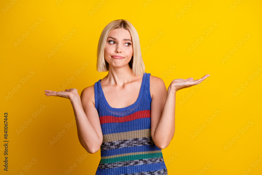 Photo portrait of young sweet beautiful woman student shrugging shoulders having dilemma in singlet isolated on yellow color background Photo portrait of young sweet beautiful woman student shrugging shoulders having dilemma in singlet isolated on yellow color background