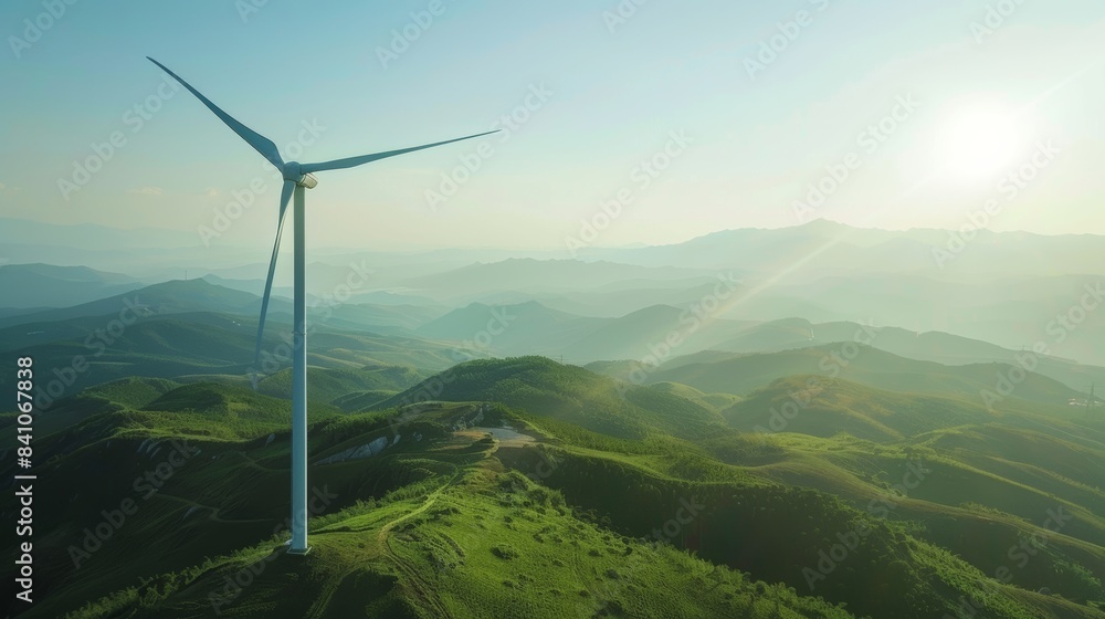 A wind turbine standing tall against a backdrop of rolling hills. A wind turbine standing tall against a backdrop of rolling hills.