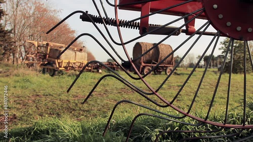 A Vintage Star-Wheel Rake at a Rural Field at Sunset. Close Up. 4K Resolution. photo