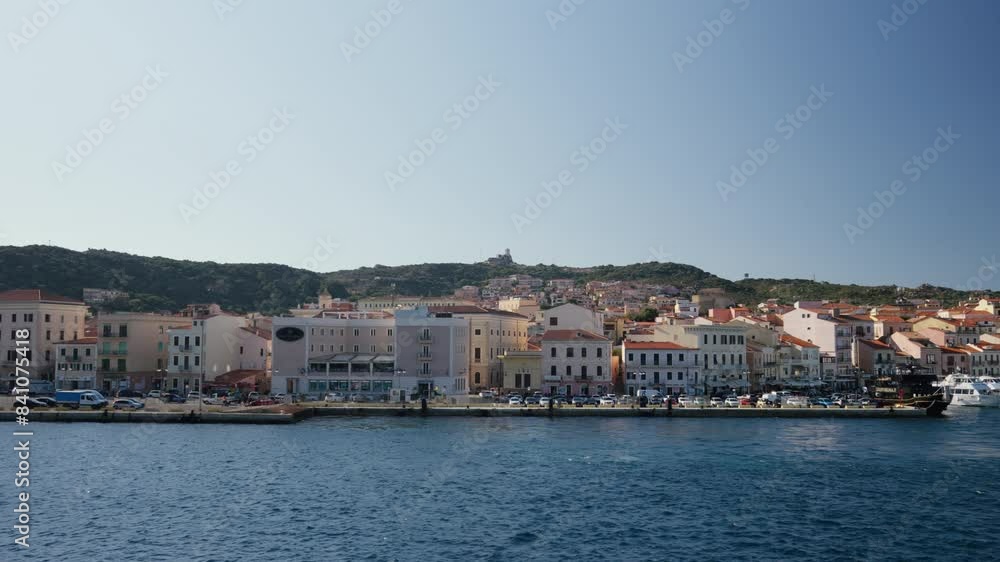 La Maddalena coastal town with colorful buildings and boats. View from water. La Maddalena coastal town with colorful buildings and boats. View from water.
