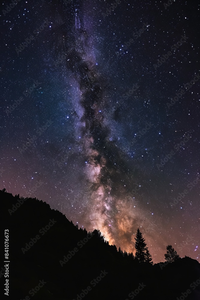 Breathtaking night sky filled with millions of stars and the Milky Way galaxy arching over a silhouette of mountain peaks, evoking wonder and the vastness of the universe Breathtaking night sky filled with millions of stars and the Milky Way galaxy arching over a silhouette of mountain peaks, evoking wonder and the vastness of the universe
