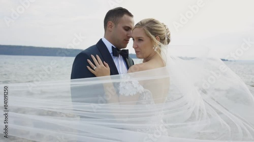 Veil blows in the window in front of couple