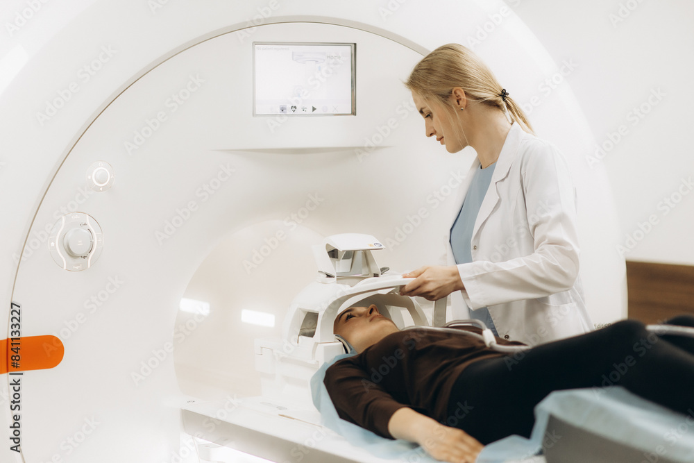 Radiologist with a female patient in the room of computed tomography Radiologist with a female patient in the room of computed tomography