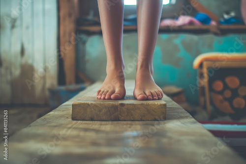 Child's feet on wooden plank indoors photo