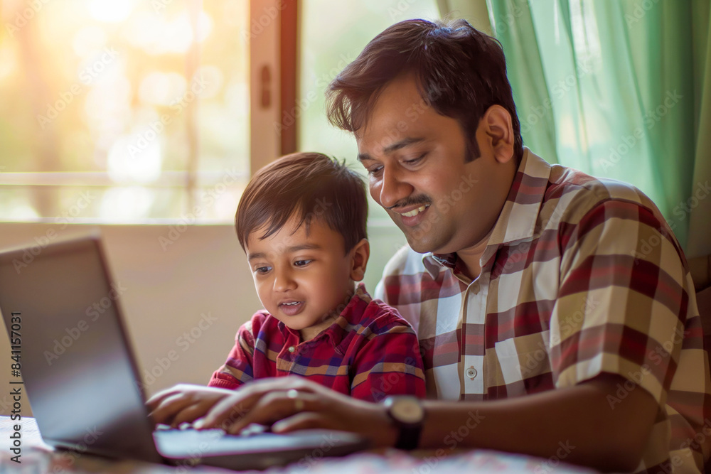 Indian father and young son enjoying bonding time over a laptop at home, engaging in fun and leisure activities. sunset background Indian father and young son enjoying bonding time over a laptop at home, engaging in fun and leisure activities. sunset background