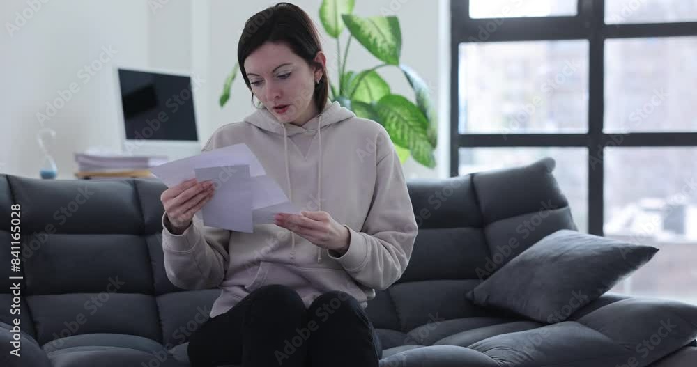 Woman emotional negative reaction to a paper letter Woman emotional negative reaction to a paper letter