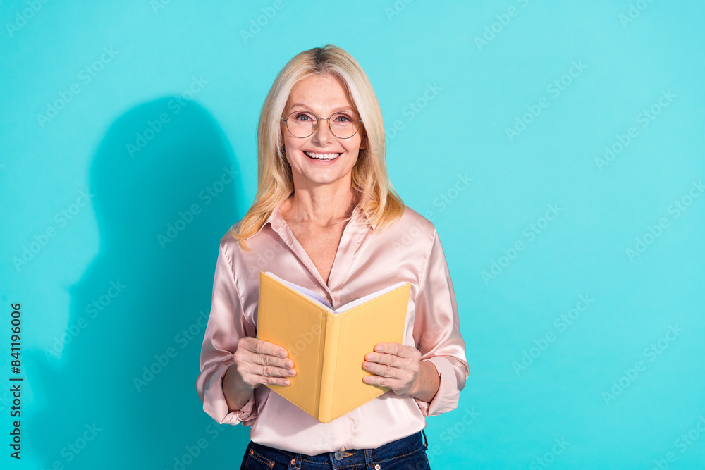 Portrait of pretty elegant lady hold book empty space wear shirt isolated on turquoise color background Portrait of pretty elegant lady hold book empty space wear shirt isolated on turquoise color background