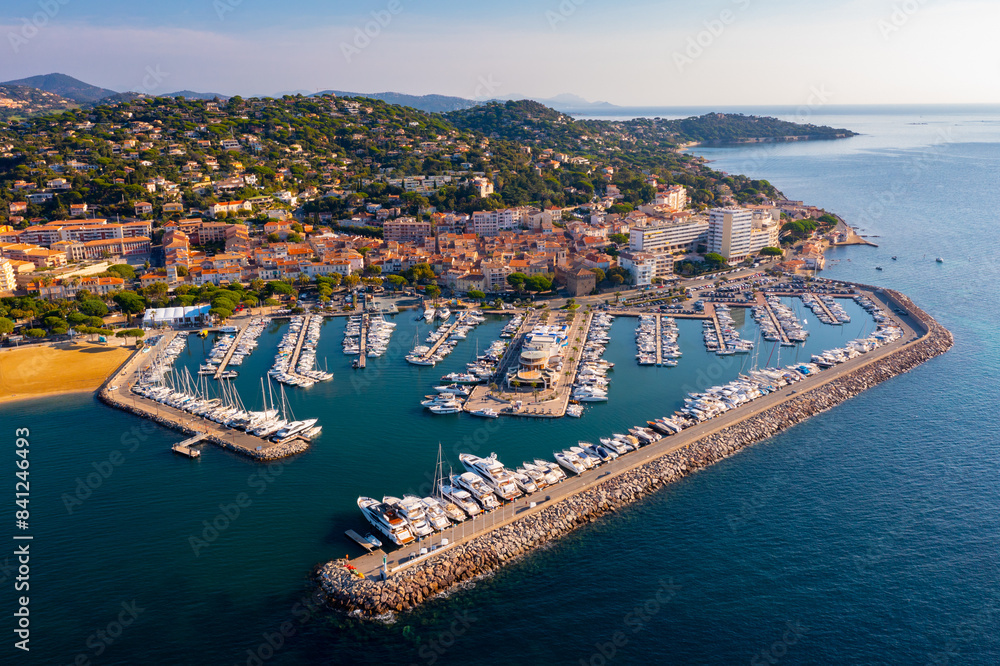 Picturesque view from drone of Sainte-Maxime townscape on Mediterranean coast with port for pleasure yachts on sunny autumn day, France