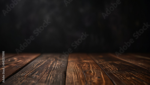 Empty dark wooden table top or surface on blurred black background. Banner with copy space. Template showcase scene for display, montage, advertising product.