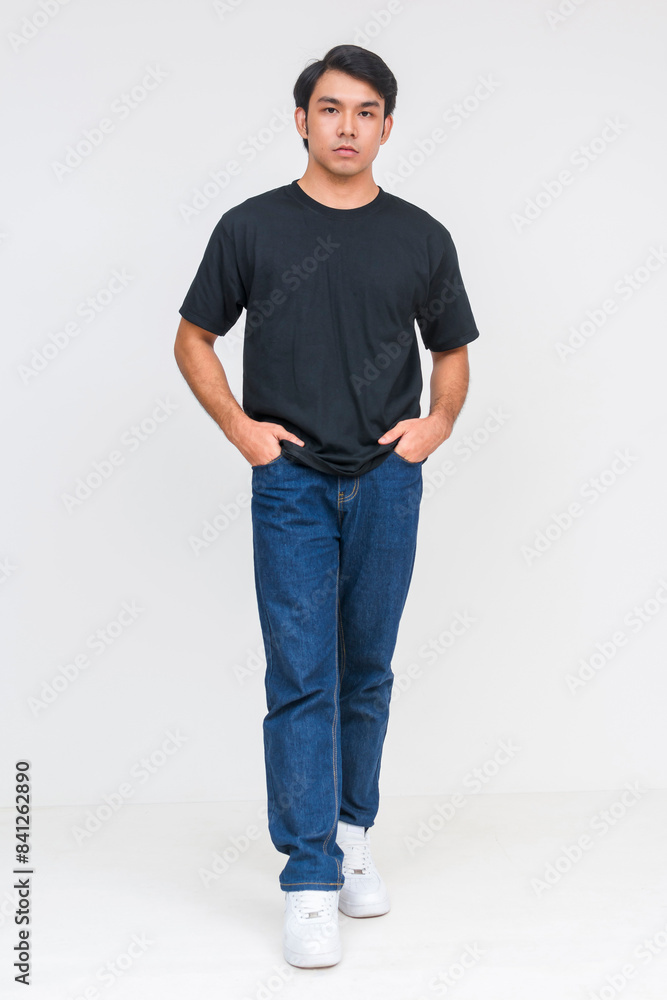 Fototapeta premium Casual asian man in black shirt and jeans standing confidently
