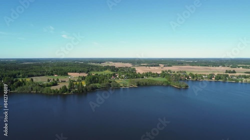 Rural aerial background: Flyover forest, agriculture fields and lake photo