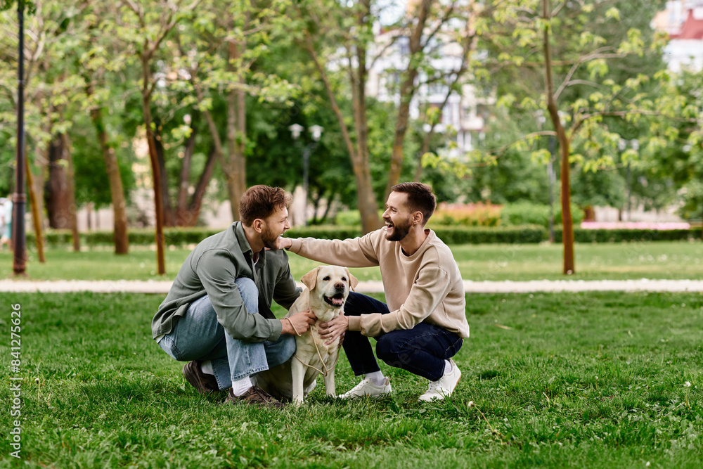 A bearded gay couple smiles while spending quality time with their labrador retriever in a green park. A bearded gay couple smiles while spending quality time with their labrador retriever in a green park.