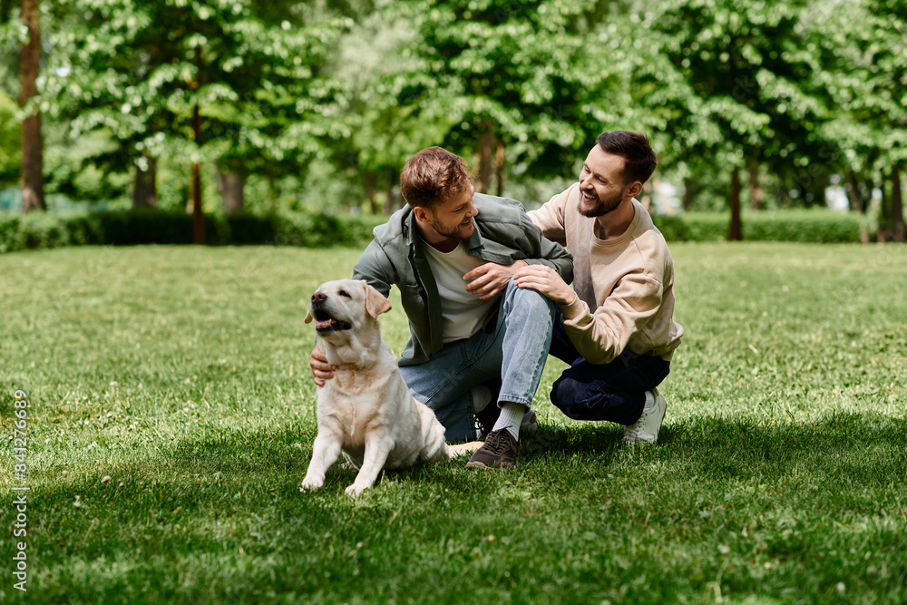 A gay couple with beards and casual attire spends a sunny day in a green park with their labrador retriever. A gay couple with beards and casual attire spends a sunny day in a green park with their labrador retriever.
