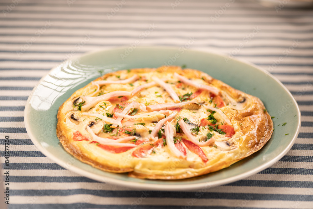 Tasty omelette with bacon and tomatoes on a white plate. Healthy breakfast Tasty omelette with bacon and tomatoes on a white plate. Healthy breakfast