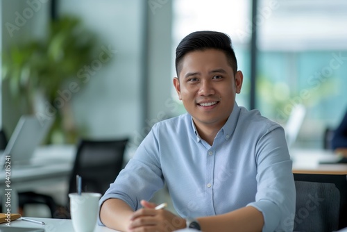 Portrait of male Filipino handsome business leader, modern bright office boardroom, professional atmosphere, leadership, diverse workplace, corporate setting.