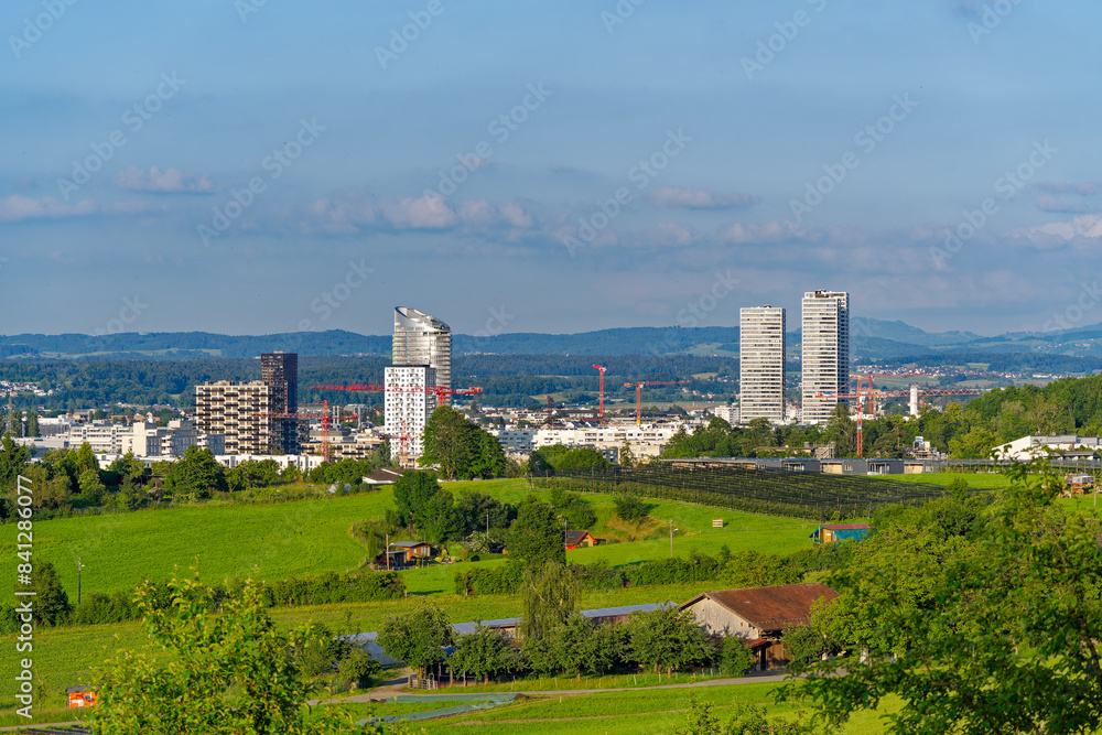 Skyline of Swiss City of Stettbach Dübendorf seen from Swiss City of Zürich on a sunny spring evening. Photo taken June 4th, 2024, Zürich, Switzerland.