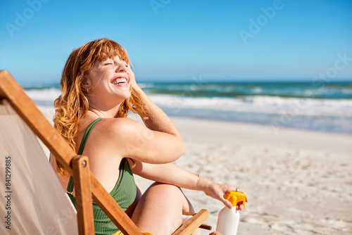 Fotografie Carefree curvy woman relaxing on deck chair at tropical beach