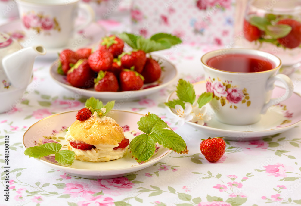 cup of tea with cream fuff and strawberries cup of tea with cream fuff and strawberries