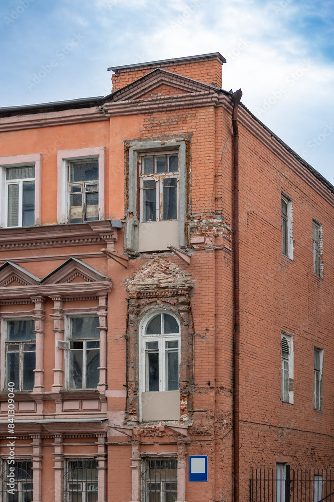 Fototapeta premium The facade of a red brick building against a blue sky