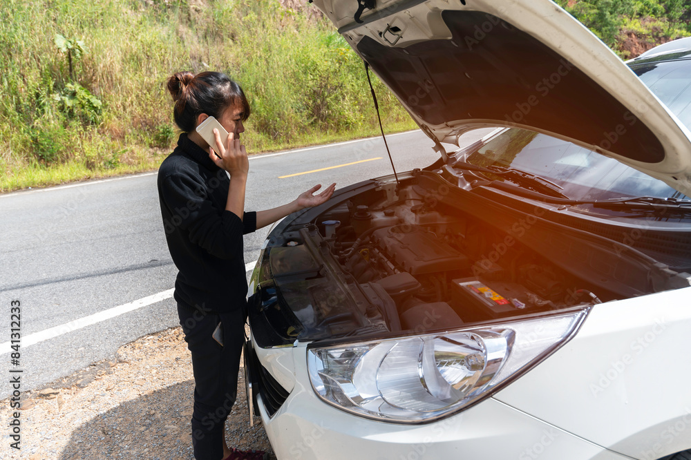 Naklejka premium Asian tourist Young woman is calling to car mechanic to repair broken car.