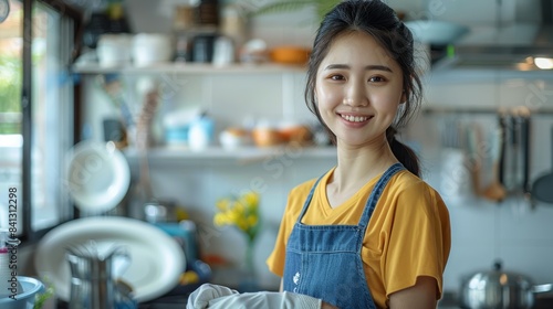 Young Asian lady smiling and cleaning in a modern home. Generative AI. © visoot
