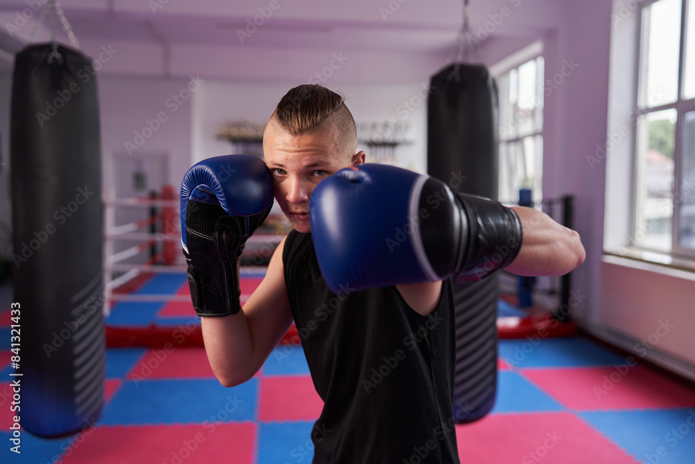 Young boxer doing shadow boxing in a gym Young boxer doing shadow boxing in a gym