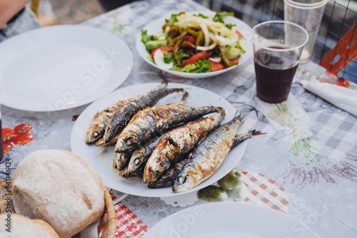 Wallpaper Mural A bunch of grilled sardines on a plate, traditional salad, sangria, bread on a table. Saint Anthony holidays in Lisbon in June  Torontodigital.ca