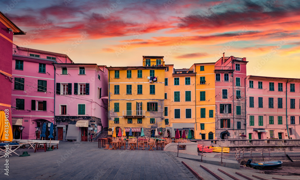Obraz premium Old colorful buildings on the empty bank of Vernazza port. Amezing sunrise of Liguria, Cinque Terre region, Italy, Europe. Traveling concept background..