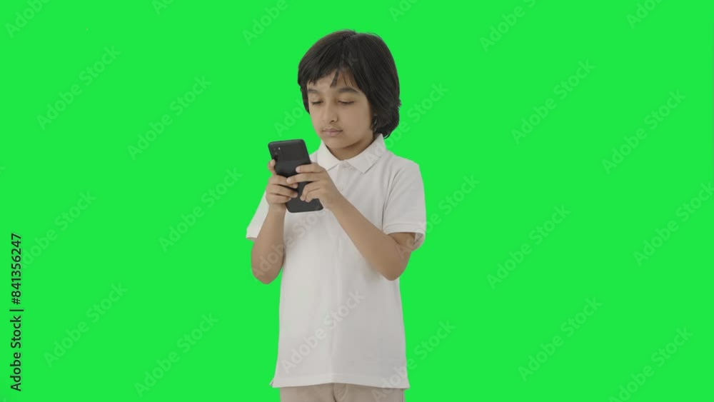 Indian boy texting someone on phone Green screen Indian boy texting someone on phone Green screen