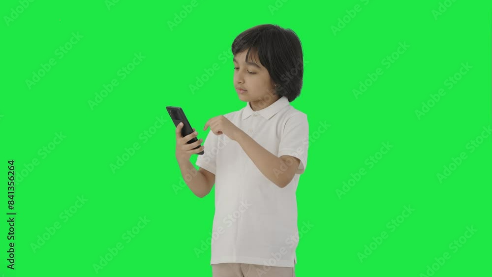 Indian boy scrolling through phone Green screen Indian boy scrolling through phone Green screen