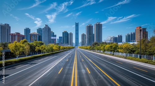 A long, empty road with a few buildings in the background