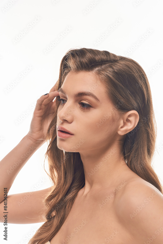 A young beautiful woman with long wavy hair striking a pose, exuding confidence and elegance. A young beautiful woman with long wavy hair striking a pose, exuding confidence and elegance.