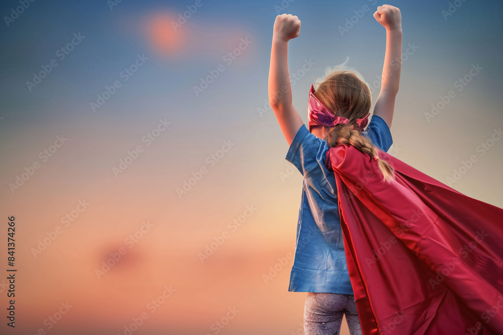 a little girl in a red cape and blue shirt a little girl in a red cape and blue shirt
