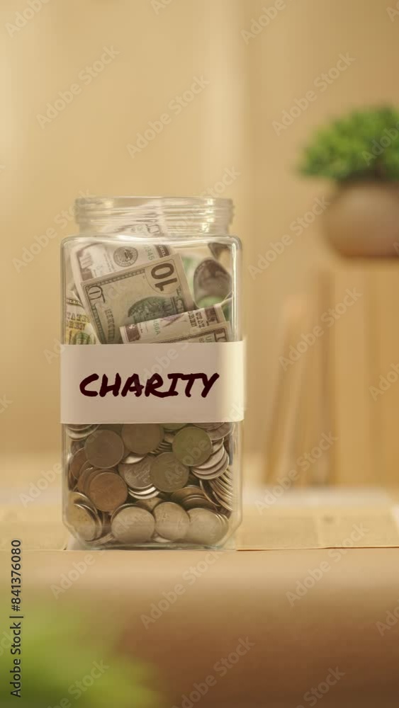 VERTICAL VIDEO OF PERSON SAVING MONEY FOR CHARITY VERTICAL VIDEO OF PERSON SAVING MONEY FOR CHARITY