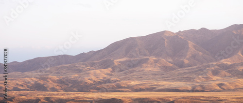 Autumn landscape of vast plains in China. Breathtaking, amazing, endless desert mountain landscapes bordering the Gobi Desert.