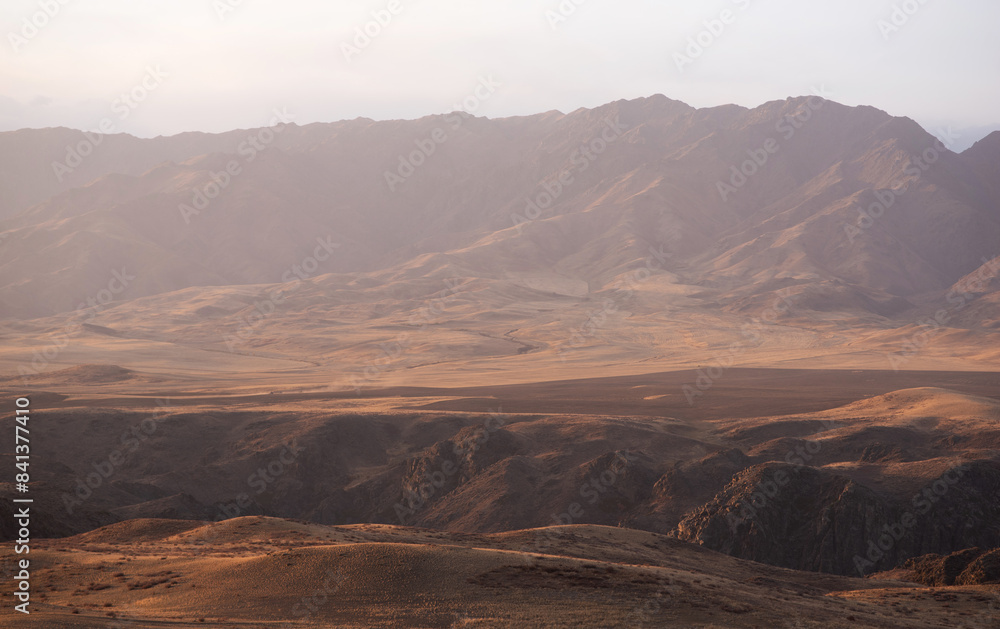 Fototapeta premium Autumn landscape of vast plains in China. Breathtaking, amazing, endless desert mountain landscapes bordering the Gobi Desert.