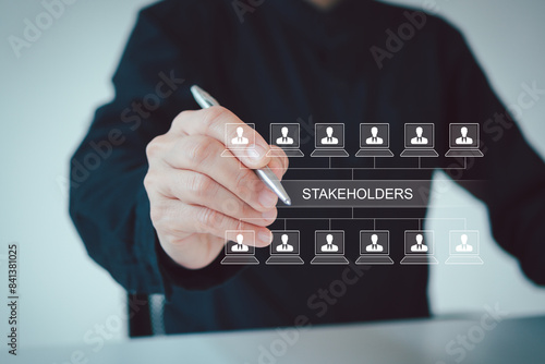 Stakeholders concept. Person touching stakeholders icon on virtual screen for business finance stakeholder investment management. Different stakeholders contact collaboration for company organization photo