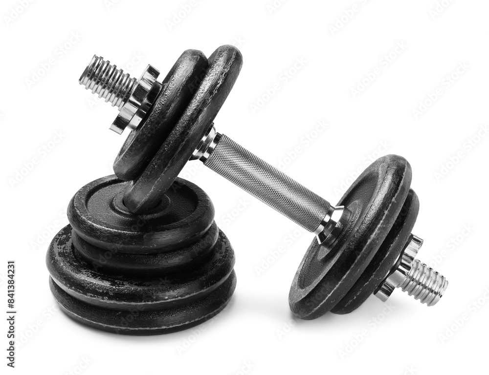 Metal dumbbells and weight plates on white background. Sports equipment Metal dumbbells and weight plates on white background. Sports equipment