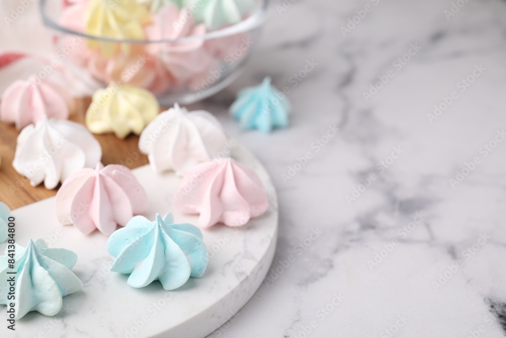 Tray with tasty meringue cookies on white marble table, closeup. Space for text Tray with tasty meringue cookies on white marble table, closeup. Space for text