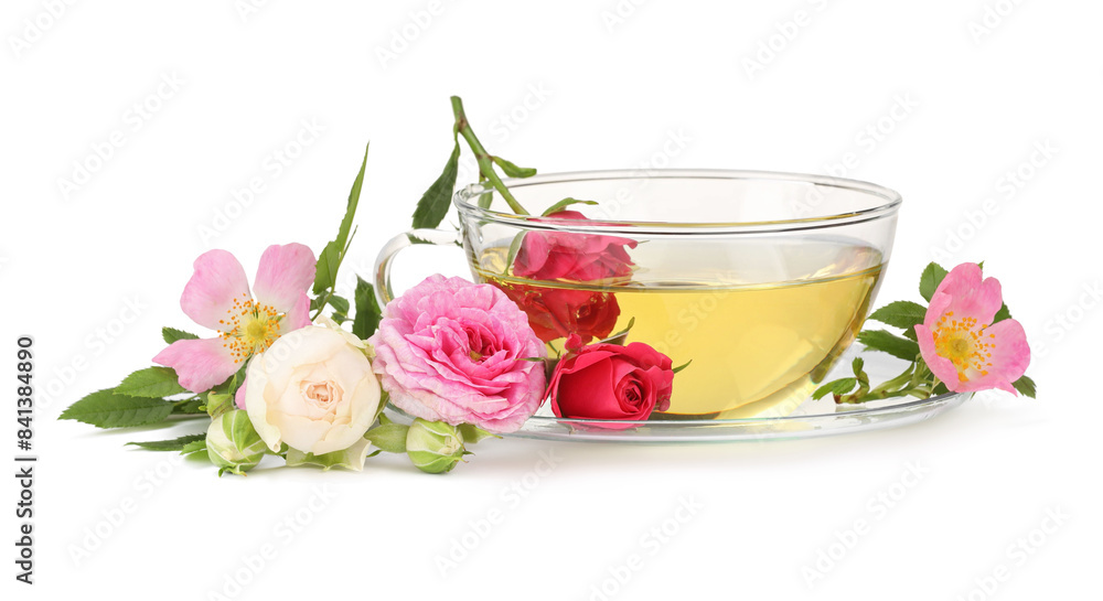 Aromatic herbal tea in glass cup and flowers isolated on white Aromatic herbal tea in glass cup and flowers isolated on white