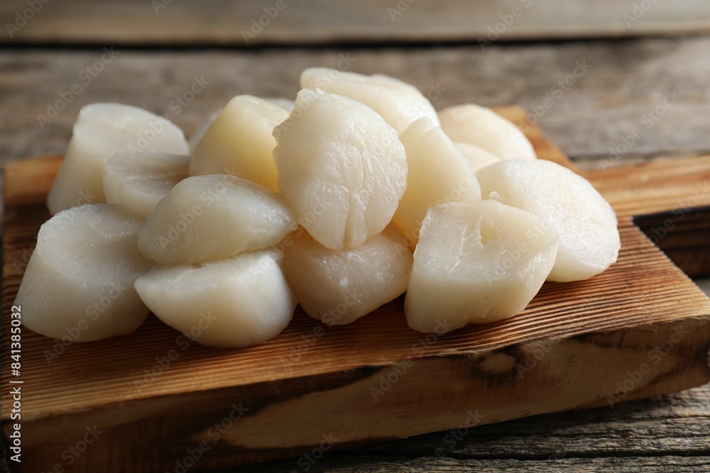 Fresh raw scallops on wooden table, closeup Fresh raw scallops on wooden table, closeup