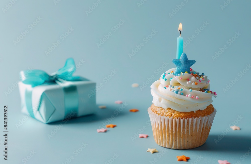 Cupcake with candle and present box celebration blue theme Cupcake with candle and present box celebration blue theme