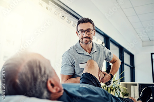 Physiotherapist, senior man and stretching leg for knee pain, medical and consultant with fitness injury. Consultation, chiropractor and physical therapy with rehabilitation and care in doctor office photo