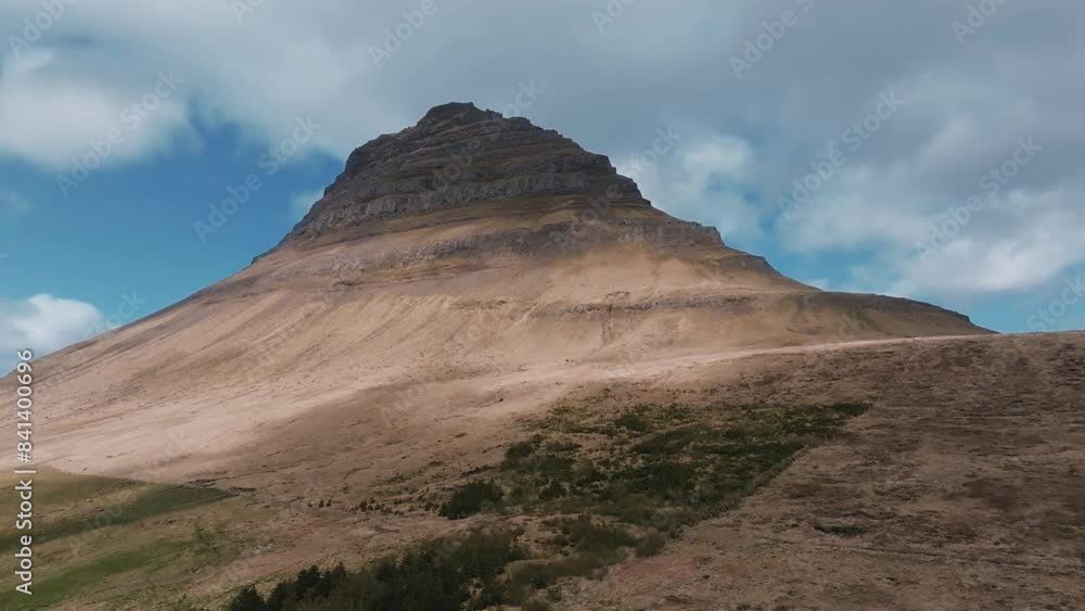 The famous Kirkjufell with Kirkjufellfoss Waterfall in the summer located on the north coast of Iceland, Snæfellsnes peninsula The famous Kirkjufell with Kirkjufellfoss Waterfall in the summer located on the north coast of Iceland, Snæfellsnes peninsula