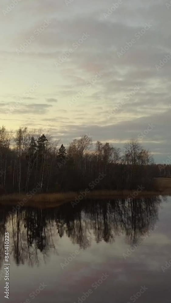 Aerial the morning drone, autumn sunrise, reflections on water surface and forest. 4k UHD Vertical shot. Aerial the morning drone, autumn sunrise, reflections on water surface and forest. 4k UHD Vertical shot.