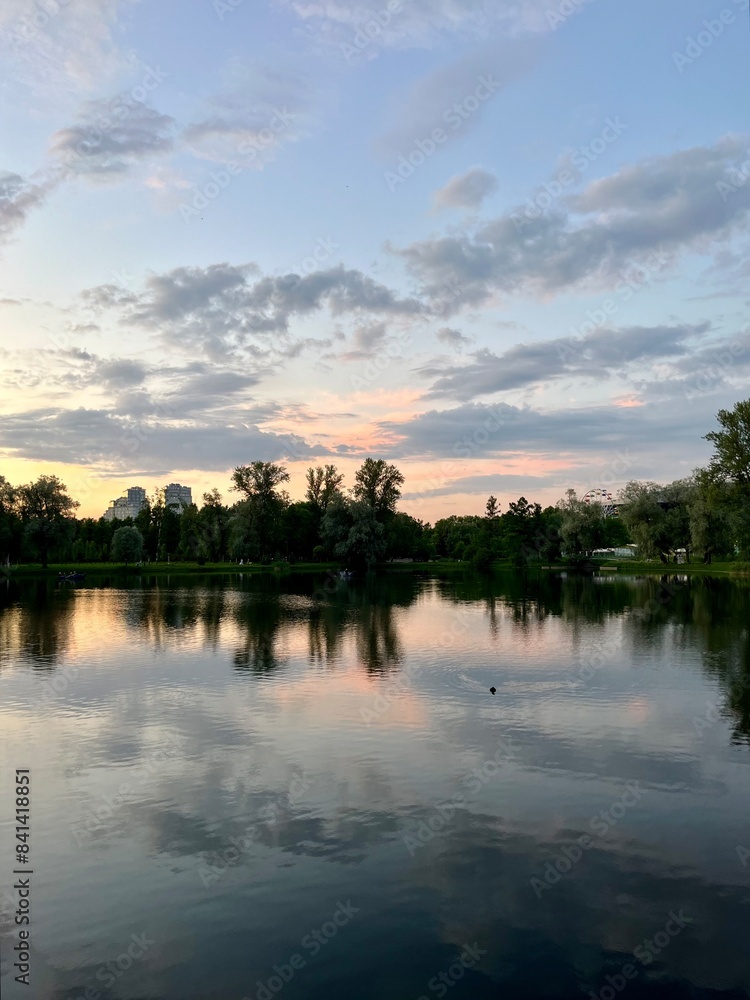 Fototapeta premium twilights at the park, sky and trees silhouettes reflection on the water surface, pond in the park, evening, summer