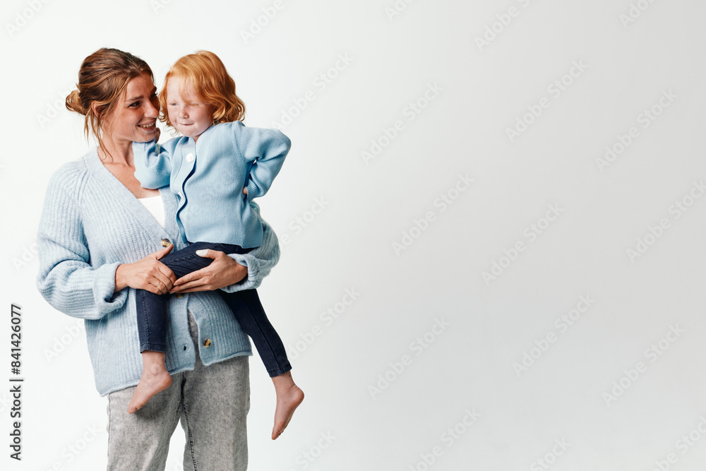 Mother and daughter embracing in front of a blank white background, love and togetherness concept, family bonding and happiness Mother and daughter embracing in front of a blank white background, love and togetherness concept, family bonding and happiness