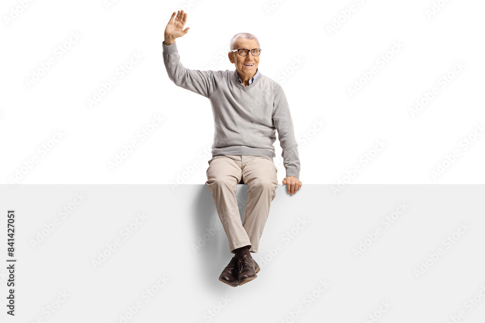 Cheerful elderly man sitting on a blank panel and waving Cheerful elderly man sitting on a blank panel and waving